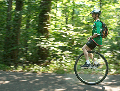 Unicyclist rides thru woods