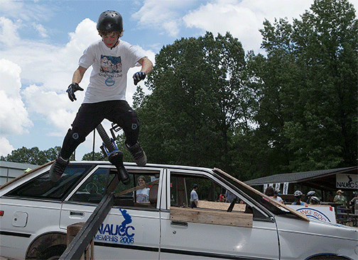 unicyclists jumps off car